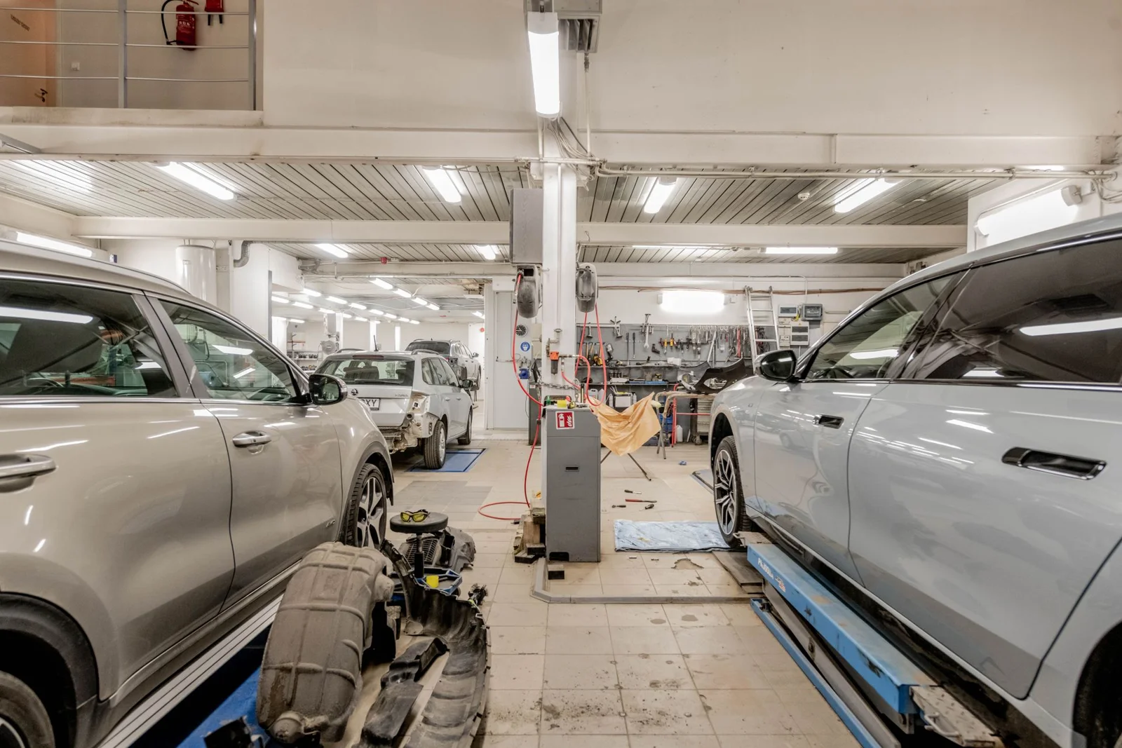 Vehicles on lifts inside the automotive workshop pictured in the Torque concept